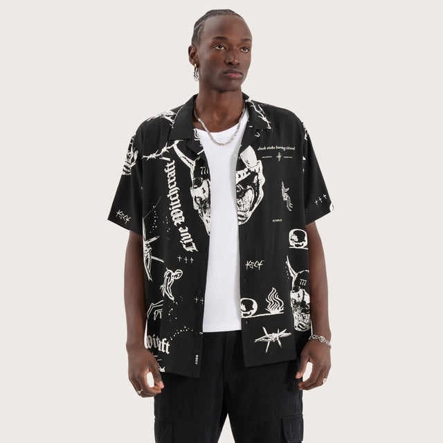 Model wears Ritual Relaxed Resort Shirt Black Print Short Sleeve Shirts in Black - Image 1