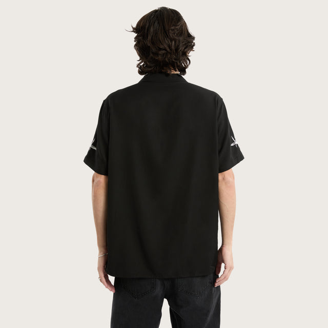 Model wears Revolver Relaxed Resort Shirt Jet Black Short Sleeve Shirts in Black - Image 5