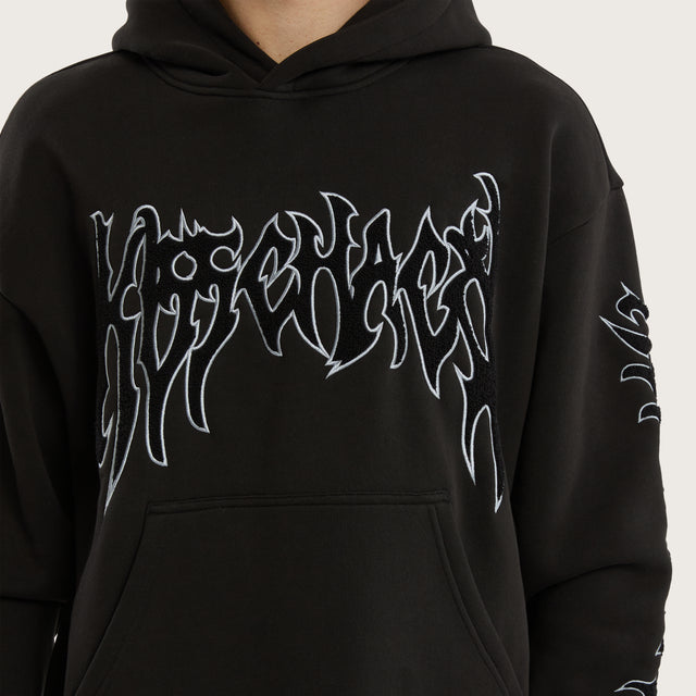 Model wears Scyth Relaxed Hoodie Jet Black Hoodies in Black - Image 5