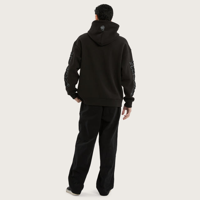 Model wears Scyth Relaxed Hoodie Jet Black Hoodies in Black - Image 7