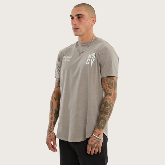 Model wears Alpha Curved Hem Tee Pigment Elephant Grey T-Shirts in Grey - Image 3