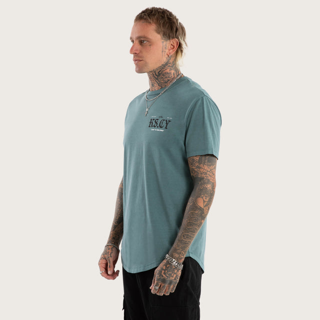 Model wears England Curved Hem Tee in Green T-Shirts in Green - Image 4