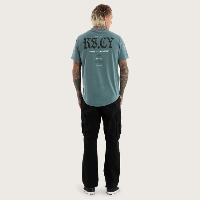 Model wears England Curved Hem Tee in Green T-Shirts in Green - Image 5