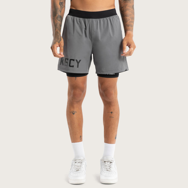 Model wears Hybrid 2.0 Sport Short Charcoal Shorts in Grey - Image 3