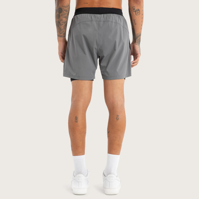 Model wears Hybrid 2.0 Sport Short Charcoal Shorts in Grey - Image 5