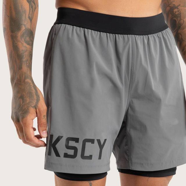 Model wears Hybrid 2.0 Sport Short Charcoal Shorts in Grey - Image 4