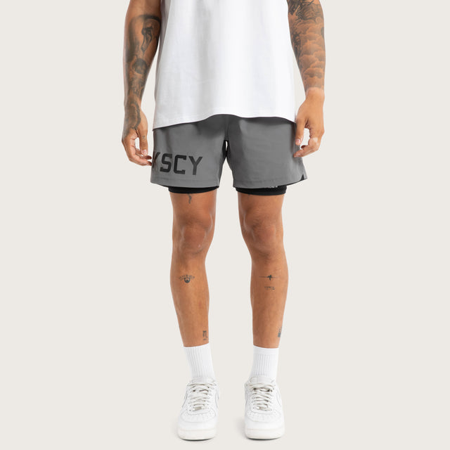 Model wears Hybrid 2.0 Sport Short Charcoal Shorts in Grey - Image 6