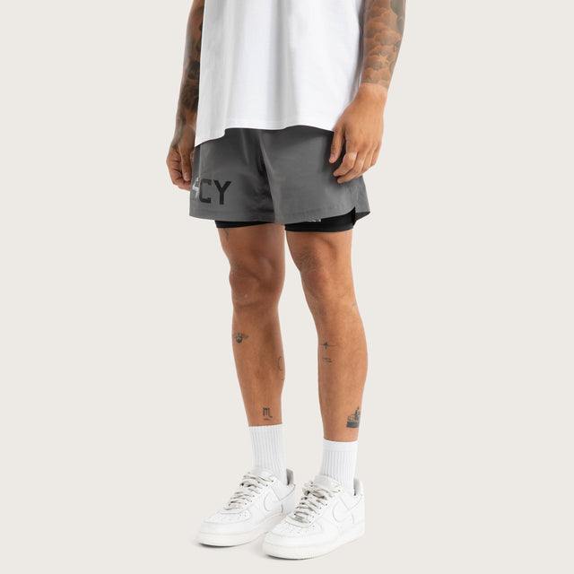 Model wears Hybrid 2.0 Sport Short Charcoal Shorts in Grey - Image 1