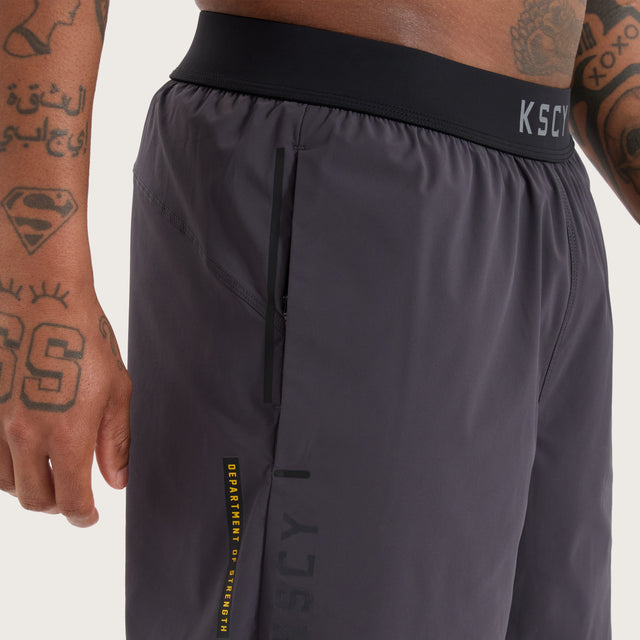 Model wears Endurance Sport Short Charcoal Shorts in Grey - Image 2