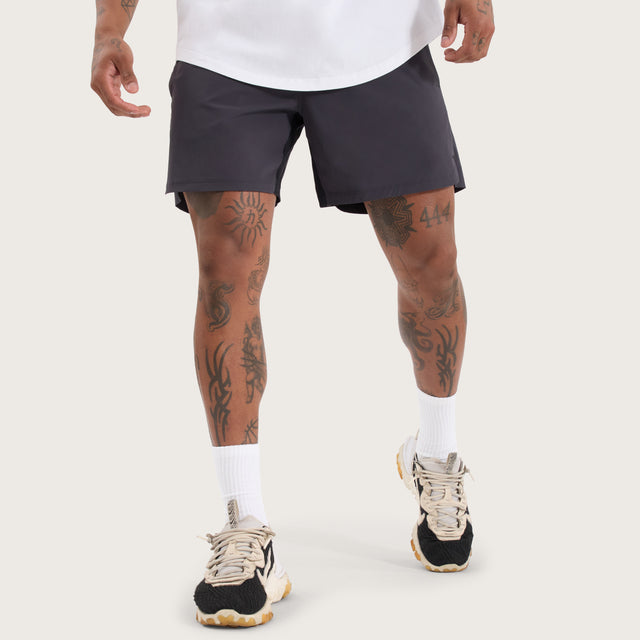 Model wears Endurance Sport Short Charcoal Shorts in Grey - Image 1