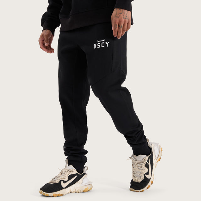 Model wears Flex Track Pant Jet Black Pants in Black - Image 1