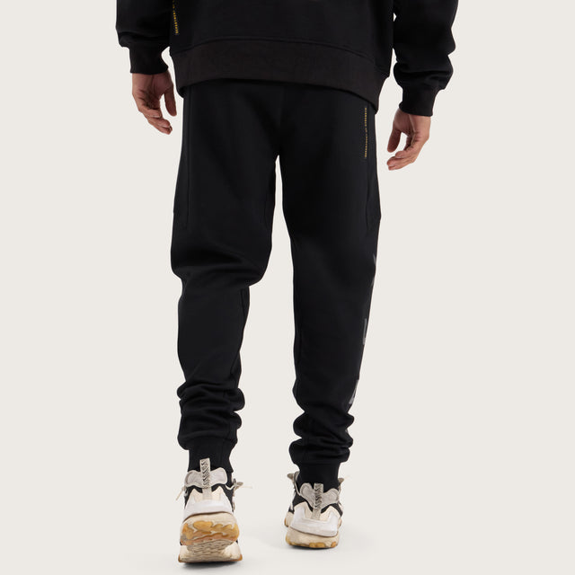 Model wears Flex Track Pant Jet Black Pants in Black - Image 6