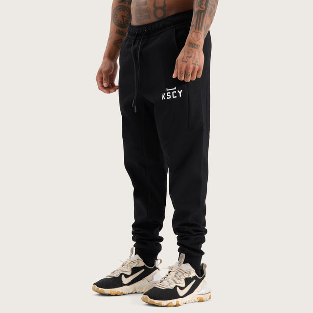 Model wears Flex Track Pant Jet Black Pants in Black - Image 8