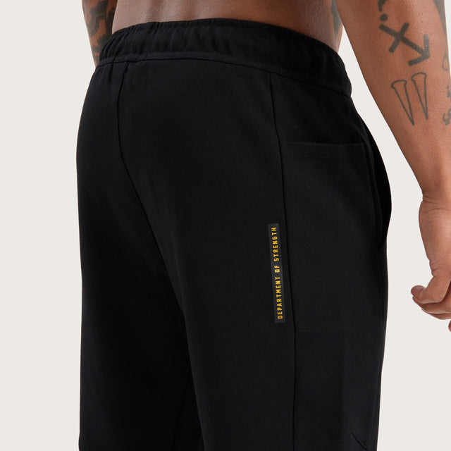 Model wears Flex Track Pant Jet Black Pants in Black - Image 5