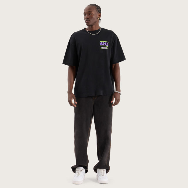 Model wears Disorder Street Tee Anthracite T-Shirts in Black - Image 7