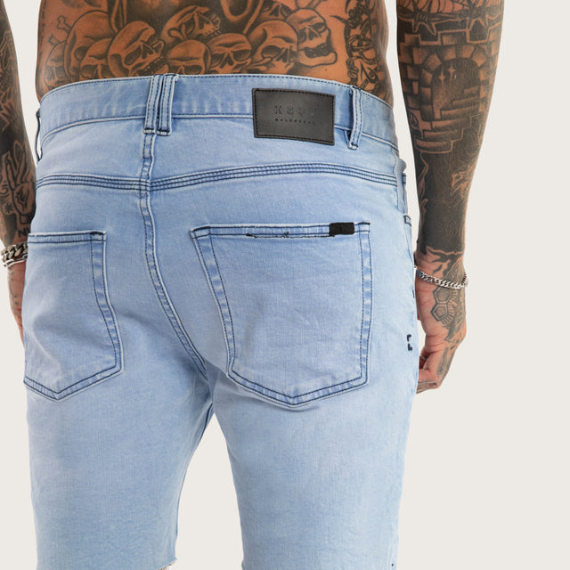Model wears KS2 Denim Short Destroyed Crystal Blue Shorts in Blue - Image 4