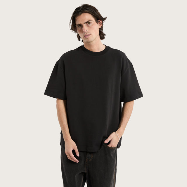 Model wears Cassius Loopback Street Tee Jet Black T-Shirts in Black - Image 1