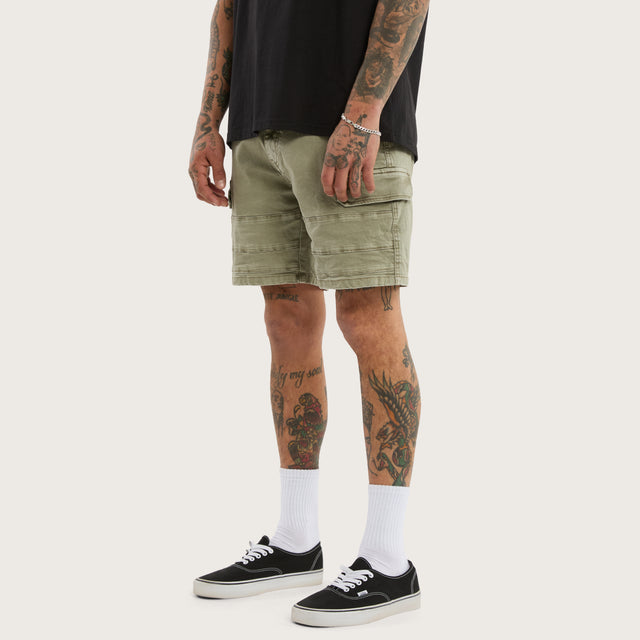 Model wears Salem Cargo Short Vintage Khaki Shorts in Green - Image 1