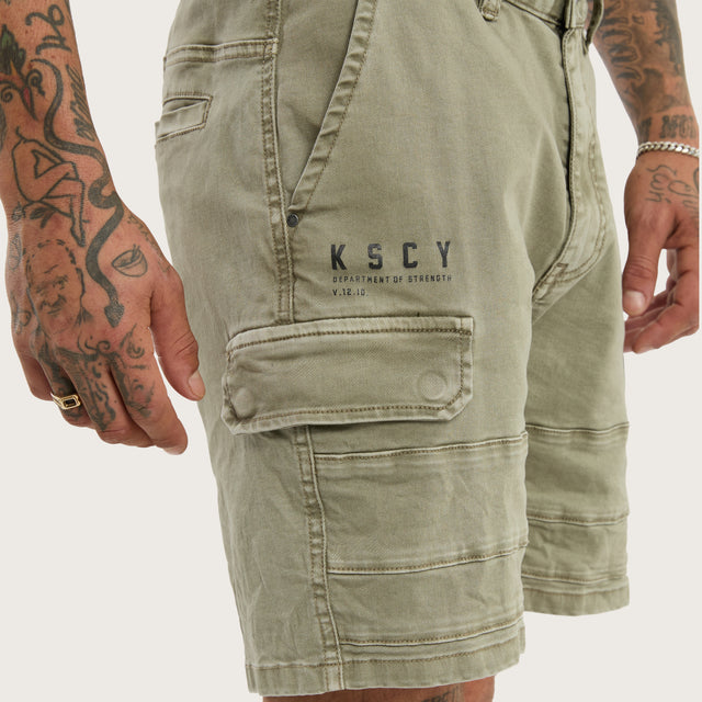 Model wears Salem Cargo Short Vintage Khaki Shorts in Green - Image 4