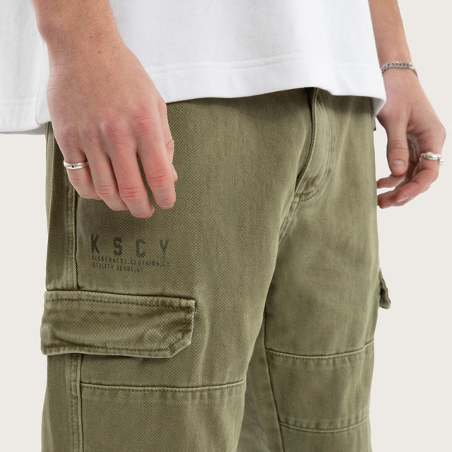 Model wears Seattle Cargo Pant Khaki Pants in Green - Image 4