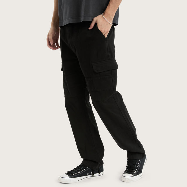 Model wears Seattle Cargo Pant Black Pants in Black - Image 1