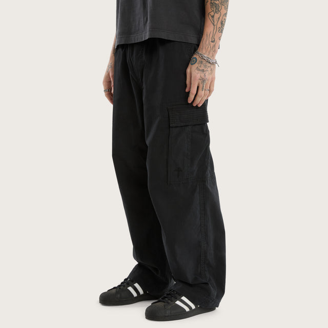 Model wears Tank Baggy Cargo Pant Washed Black Pants in Black - Image 1