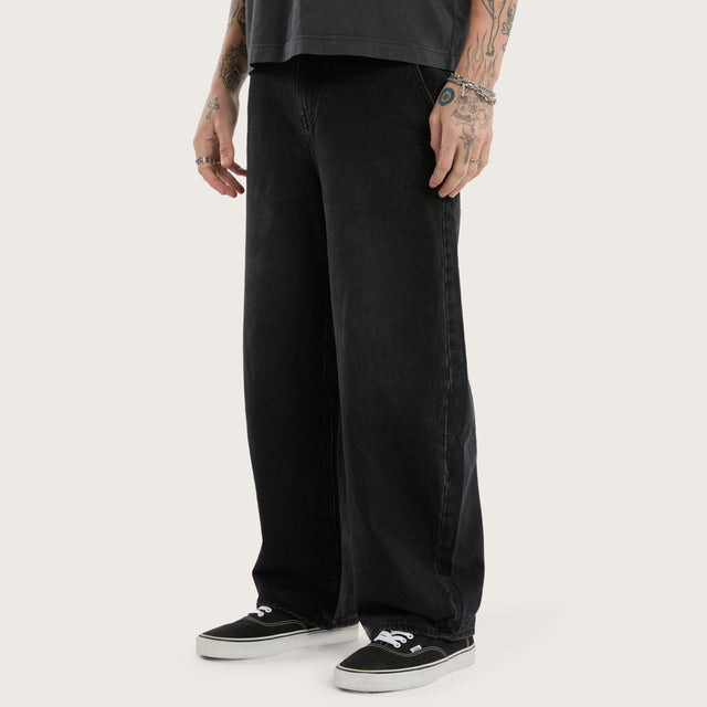Model wears K8 Balloon Jean Vintage Black Pants in Black - Image 4