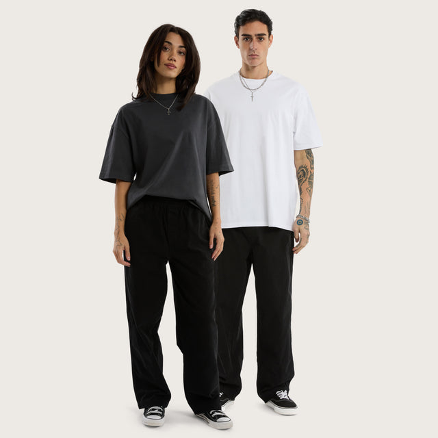 Model wears Diablo Baggy Pant Jet Black Pants in Black - Image 1