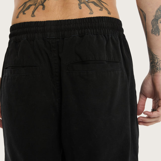 Model wears Diablo Baggy Pant Jet Black Pants in Black - Image 7