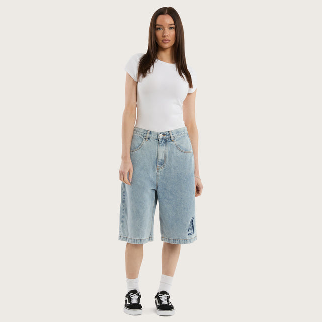 Model wears K7 Super Baggy Jorts Light Blue Shorts in 0 - Image 6