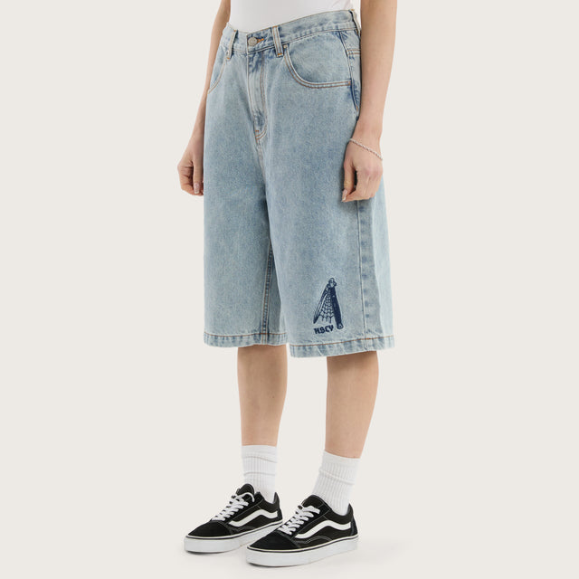 Model wears K7 Super Baggy Jorts Light Blue Shorts in 0 - Image 7
