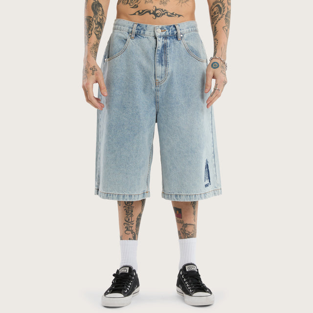 Model wears K7 Super Baggy Jorts Light Blue Shorts in 0 - Image 3