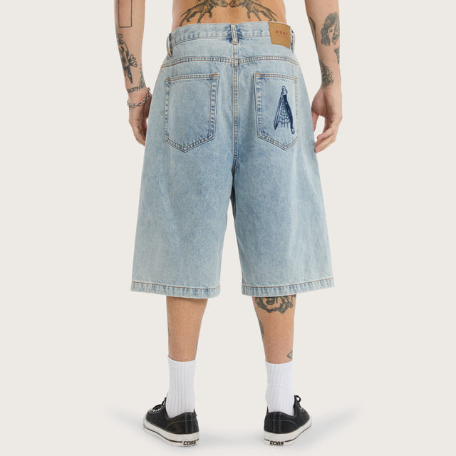Model wears K7 Super Baggy Jorts Light Blue Shorts in 0 - Image 5