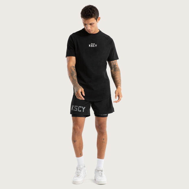 Model wears Hybrid 2.0 Sport Short Jet Black Shorts in Black - Image 2