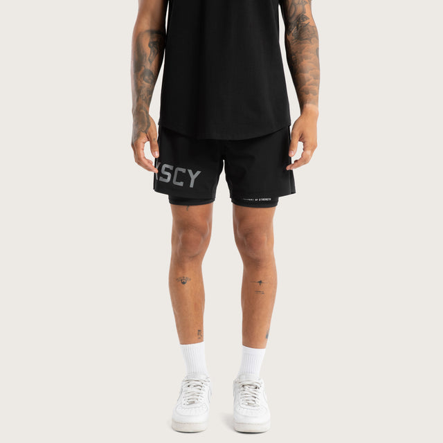 Model wears Hybrid 2.0 Sport Short Jet Black Shorts in Black - Image 6