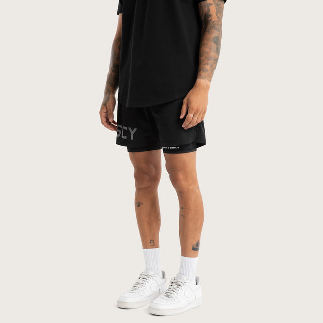 Model wears Hybrid 2.0 Sport Short Jet Black Shorts in Black - Image 1