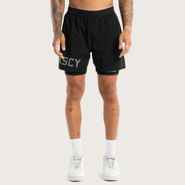 Model wears Hybrid 2.0 Sport Short Jet Black Shorts in Black - Image 3