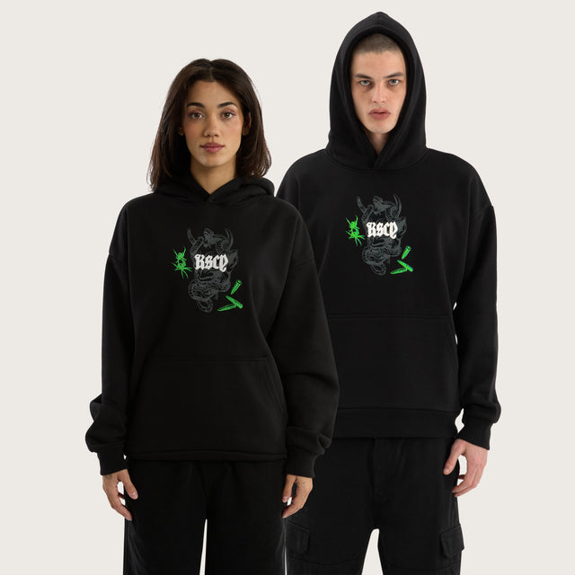 Model wears Wither Oversized Hoodie Jet Black Hoodies in Black - Image 1