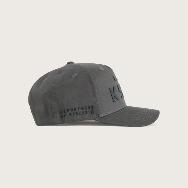 Model wears Divinity Cap Charcoal Caps in Grey - Image 4