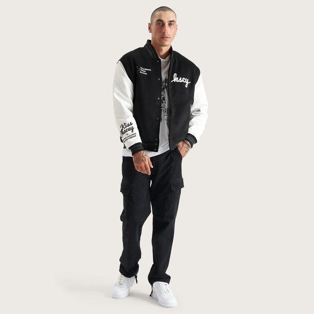 Model wears Code Vein Varsity Jacket Jet Black Jackets in Black - Image 6