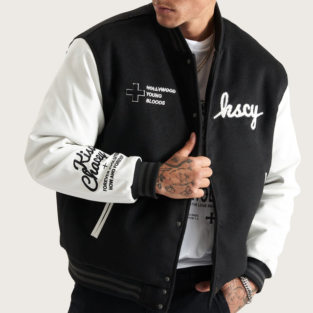 Model wears Code Vein Varsity Jacket Jet Black Jackets in Black - Image 4