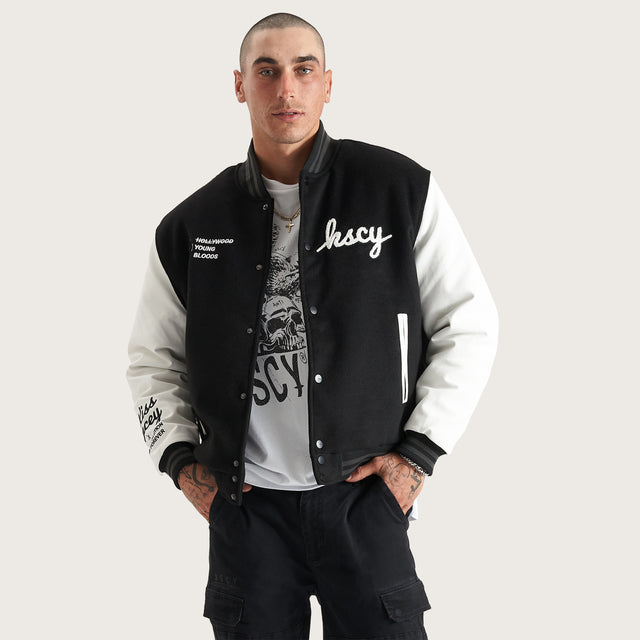 Model wears Code Vein Varsity Jacket Jet Black Jackets in Black - Image 2