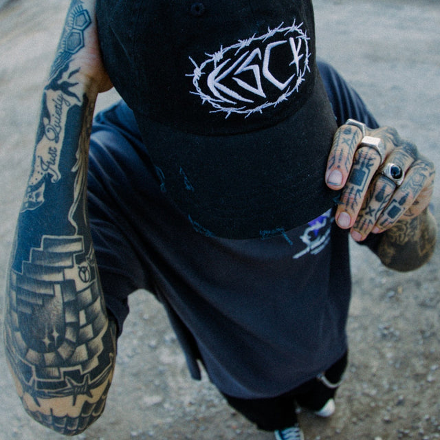 Model wears Birstall Dad Cap Jet Black Headwear in Black - Image 2