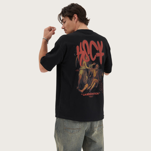 Model wears Blessing Heavy Box Fit Tee Jet Black T-Shirts in Black - Image 1