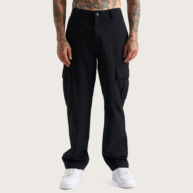 Model wears Crawford Cargo Pants Black Pants in Black - Image 1