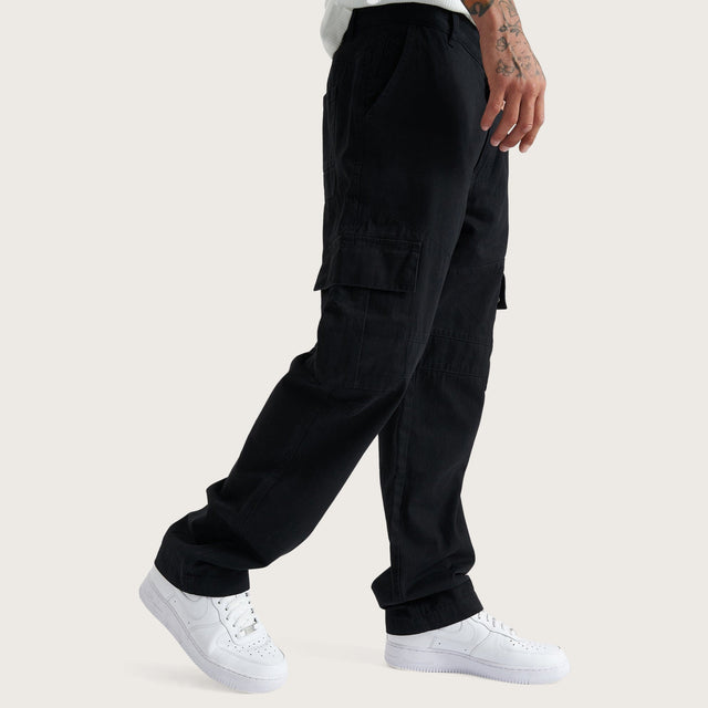 Model wears Crawford Cargo Pants Black Pants in Black - Image 2