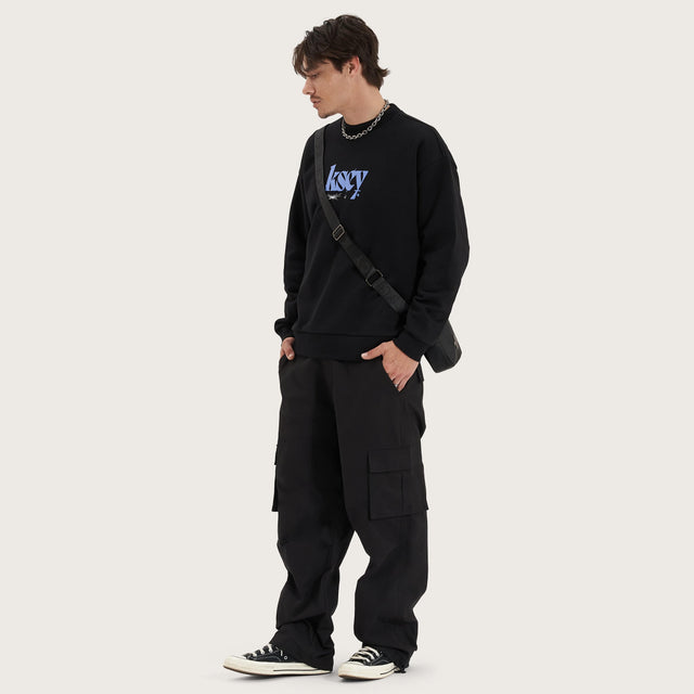 Model wears Evolved Heavy Relaxed Sweater Jet Black Jumpers in Black - Image 3