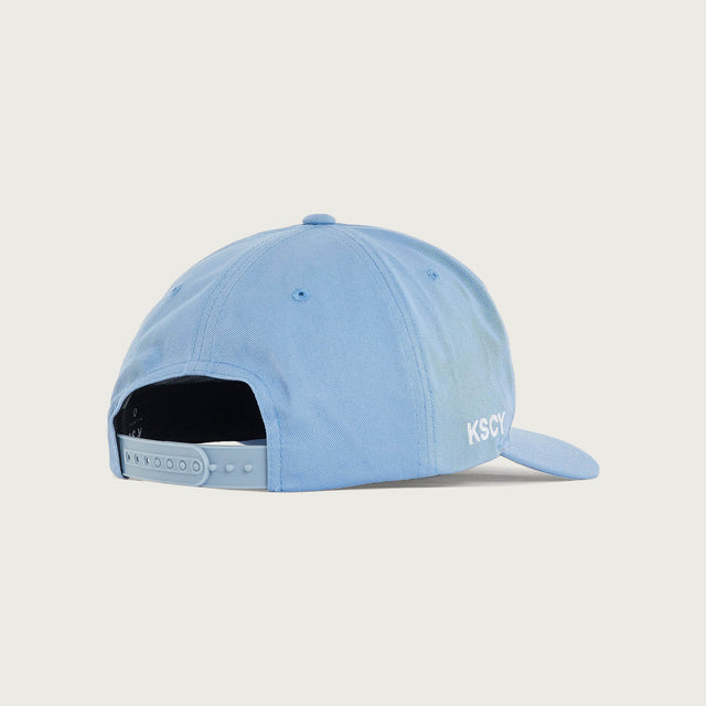 Model wears Foundation Golfer Cap Corn Flower Headwear in Blue - Image 3