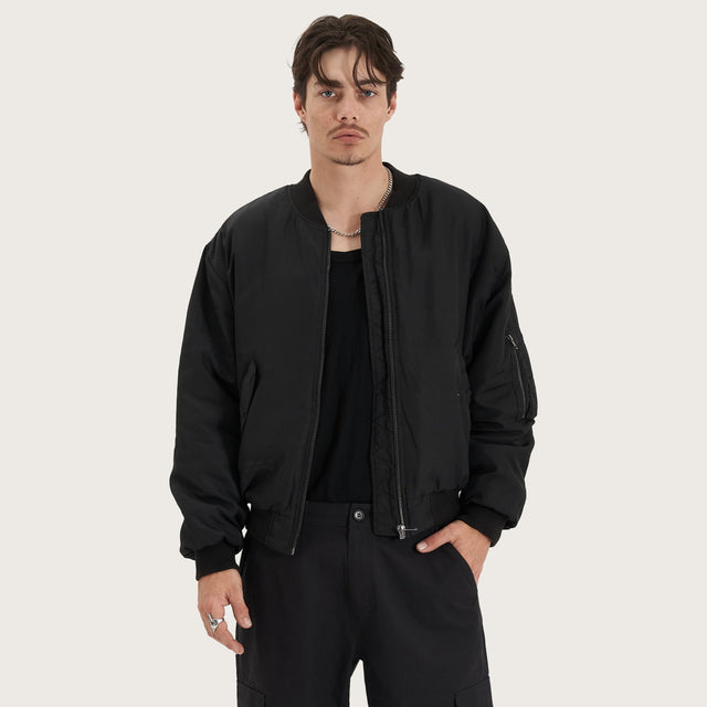 Model wears Gridlock Bomber Jacket Jet Black Jackets in Black - Image 5