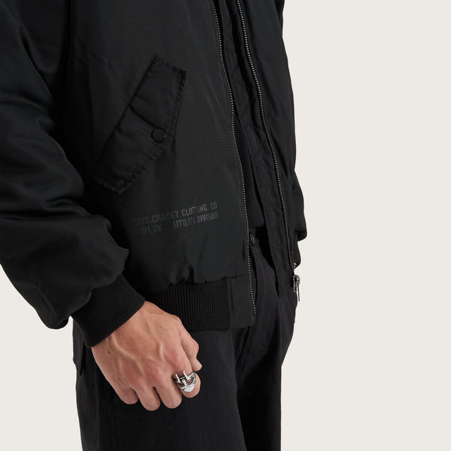 Model wears Gridlock Bomber Jacket Jet Black Jackets in Black - Image 8